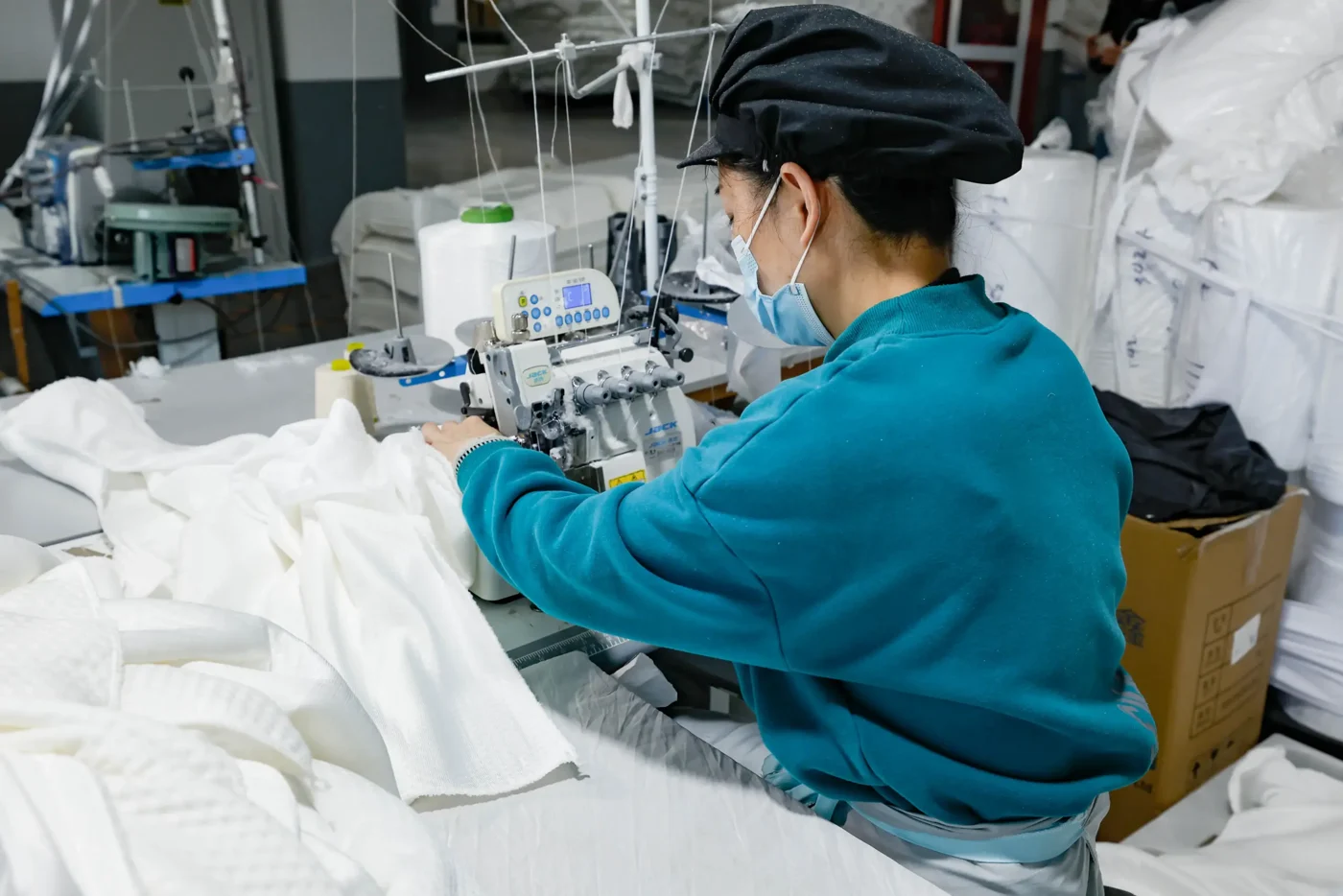 A Yintex sewing specialist working on a textile at a sewing machine