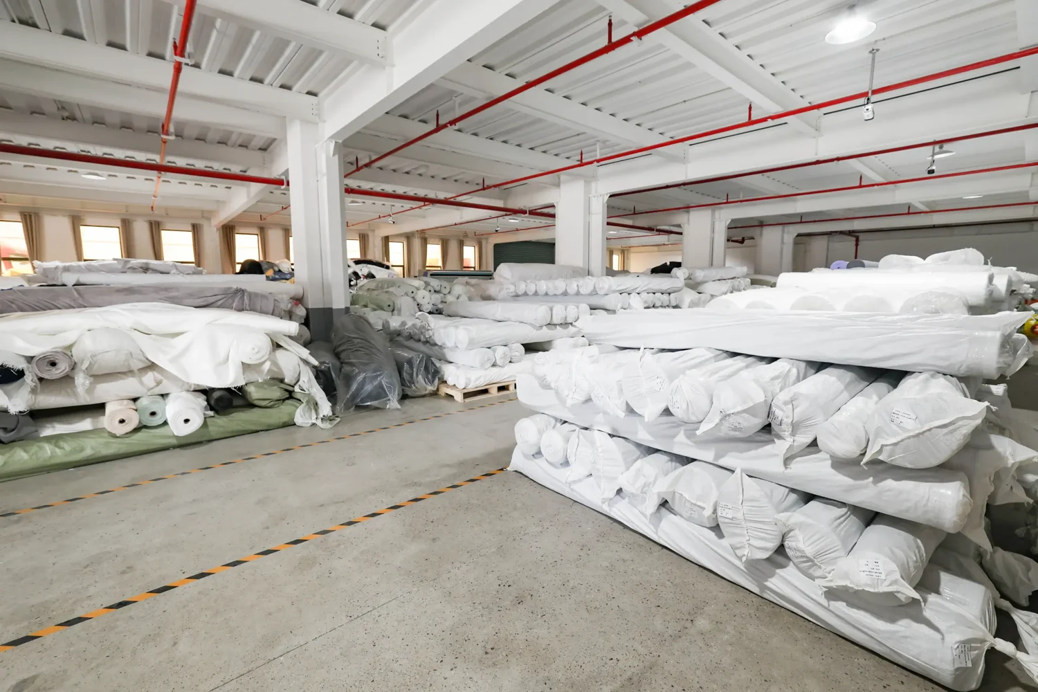 Organised rolls of textile material in the Yintex workshop