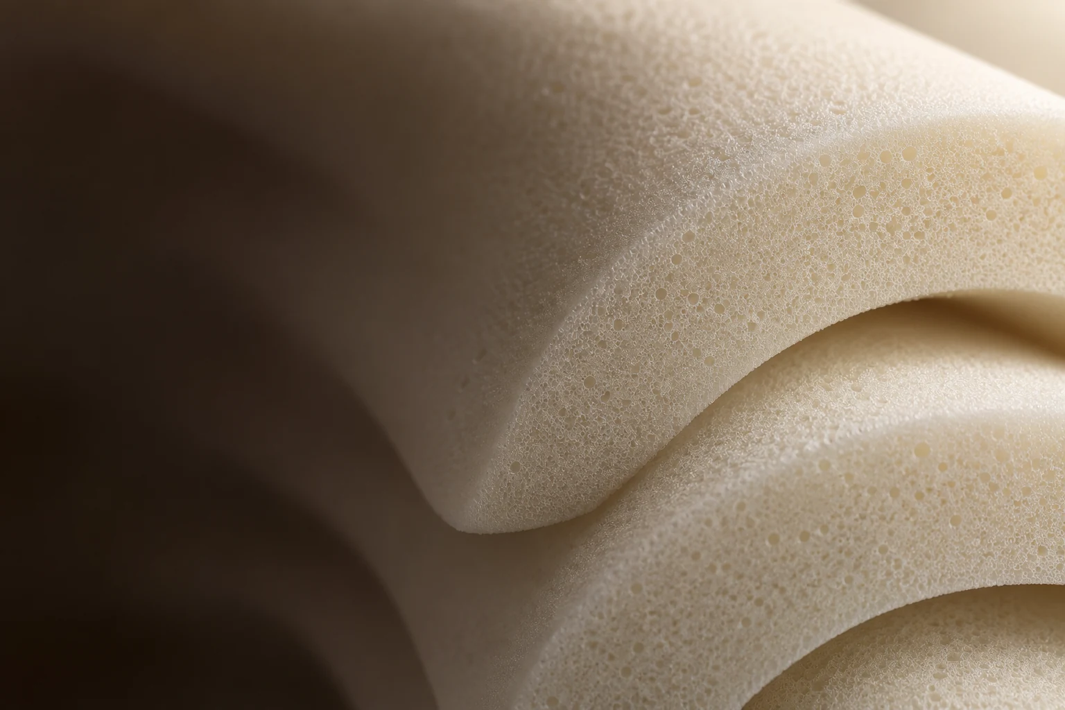 Cream memory foam with fine pores and sculpted curves