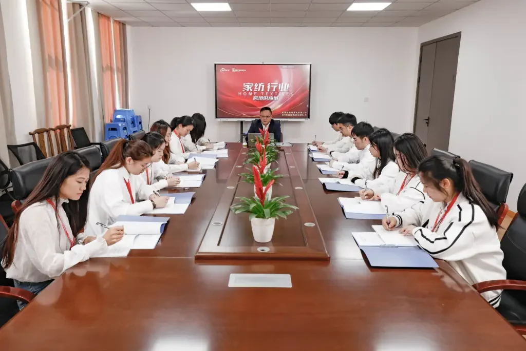 The Yintex team discussing work together around a meeting table