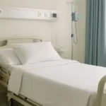 Spotlessly clean hospital bed with fresh white bedding, emphasizing hygiene and patient-ready environment