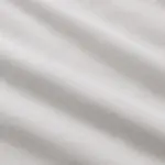 Close-up of white percale cotton bed sheets showing smooth, matte finish
