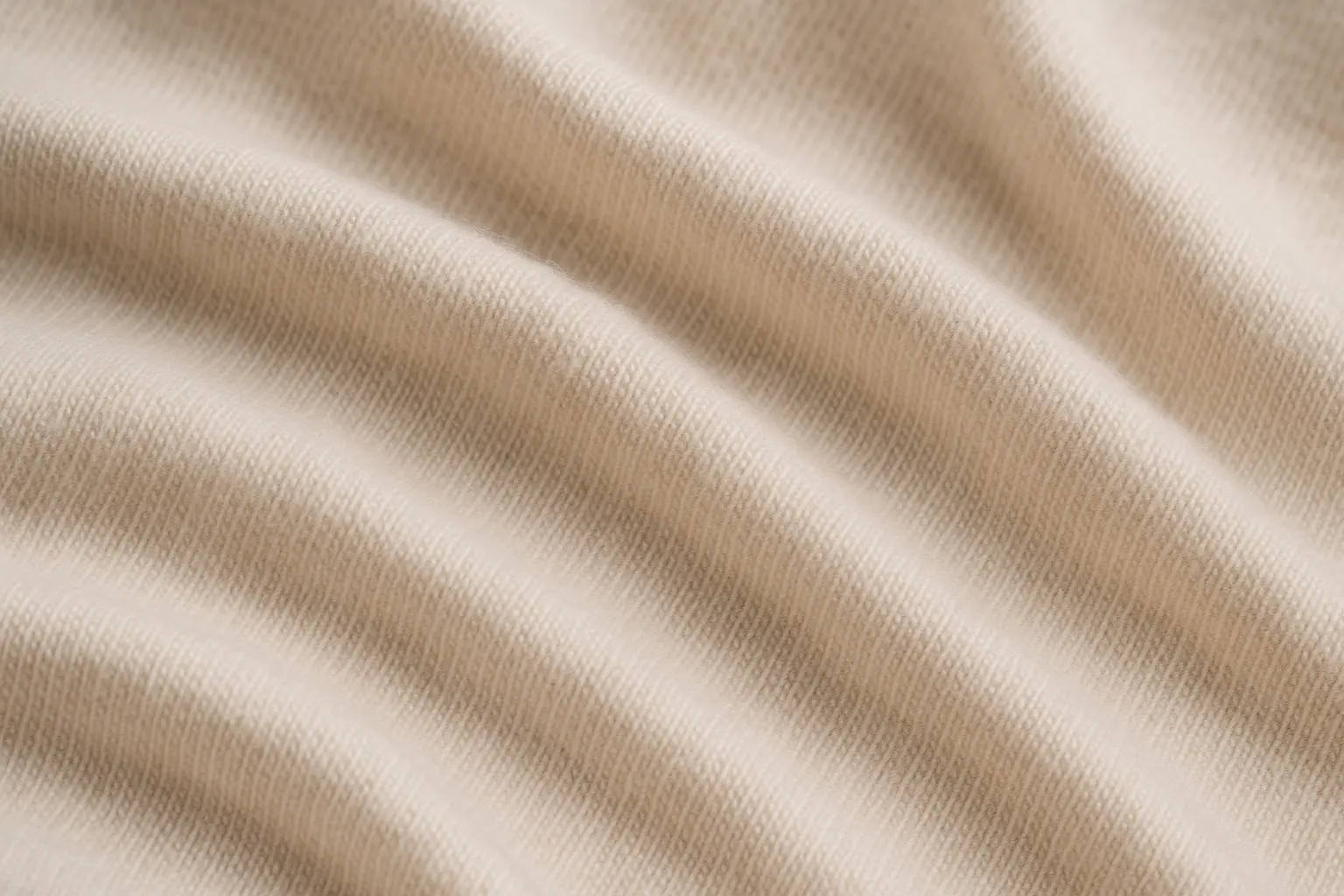 Close-up view of cotton jersey knit fabric showing soft, stretchy texture
