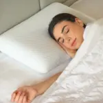 Woman sleeping on a gel-infused memory foam pillow for temperature-regulated comfort
